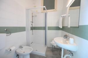 a bathroom with a shower and a toilet and a sink at Villa Diana - Beach & Rooms in Ischia