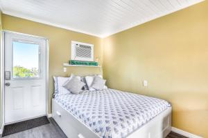 a small bedroom with a bed and a window at Fisherman's Retreat in Conch Key