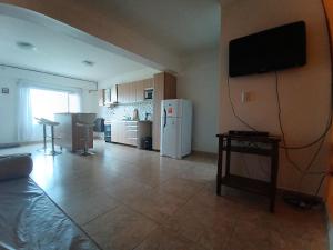 a living room with a tv on a wall at Apartamento entero - Ushuaia, Tierra del Fuego in Ushuaia