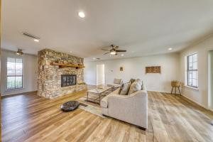 Una sala de estar con un sofá y una chimenea de piedra. en Riverfront Oasis, en Liberty Hill