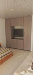 a room with wooden cabinets and a flat screen tv at Donde Memo in Santa Rosa de Cabal