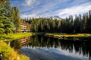 a river with trees and a mountain in the background at #103 Grand Lodge South in Government Camp