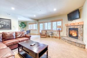 a living room with a couch and a fireplace at #201 Grand Lodge South Master Suite in Government Camp