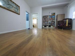 an empty living room with a hard wood floor at Green Villa in Durrës