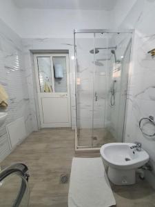 a bathroom with a shower and a toilet and a sink at Green Villa in Durrës