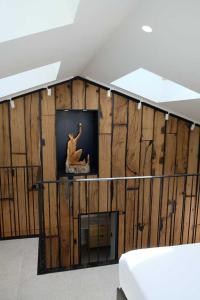 a room with a wooden wall with a vase on a shelf at Logis Hotel Erreguina in Banca