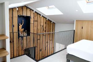 a room with a wall of wood paneling with a person on a shelf at Logis Hotel Erreguina in Banca