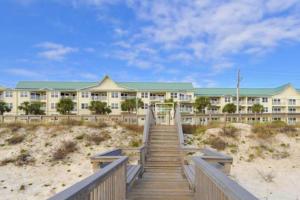 a building on the beach with a staircase leading to it at Maravilla 4409 in Destin
