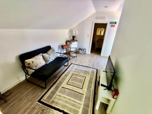 a living room with a black couch and a rug at Labrugia Villa Domus in Labruja
