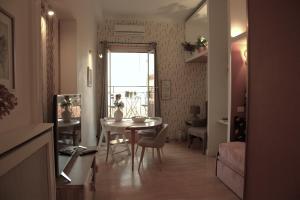 a living room with a table and a dining room at Appartamento Sofia - CISE 18741 in Rome