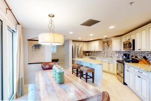 a kitchen with a table and a counter top at Westwinds 4754 in Destin