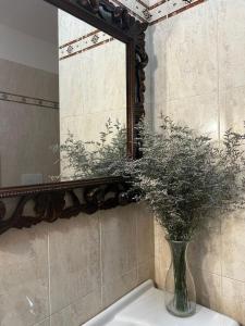 een vaas op een wastafel voor een spiegel bij Residence Girasole in Giovinazzo