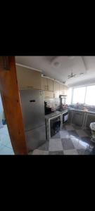 a kitchen with a refrigerator and a stove top oven at راحتي 2 in Tangier