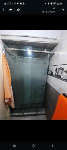 a bathroom with a shower with an orange towel at راحتي 2 in Tangier
