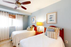 a bedroom with two beds and a ceiling fan at Westwinds 4754 in Destin