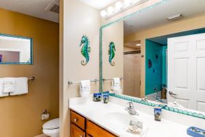 a bathroom with a sink and a mirror at Destin West Resort - Gulfside V305 in Fort Walton Beach
