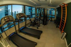 an exercise room with gym equipment in a building at Rooftop 470 - Novíssimo Flat Boa Viagem in Recife