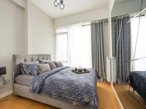 a bedroom with a bed and a large window at Divan Residence at G Tower Apartment in Istanbul