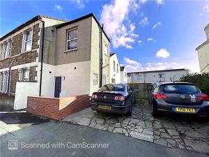 two cars parked in front of a house at Stylish 91sqm Victoria 2 bedroom Apartment in Bristol