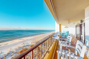a balcony with chairs and a view of the beach at Surf Dweller 704 in Fort Walton Beach