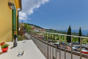a balcony with a table and a view of a city at Casa Bellavista in Capoliveri