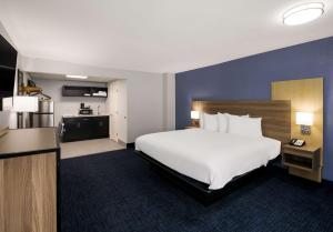 a hotel room with a large bed and a kitchen at SureStay Plus by Best Western Pigeon Forge in Pigeon Forge