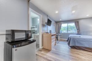 a bedroom with a bed and a television in it at Sea Treasures Inn Units #101-104, #114, & #115 in Rockaway Beach