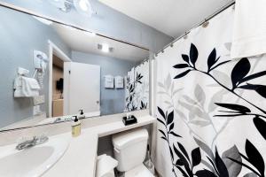 a bathroom with a toilet and a sink at Sea Treasures Inn Units #101-104, #114, & #115 in Rockaway Beach +22 photos