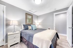 a bedroom with a bed and a lamp on a night stand at Sea Treasures Inn Units #101-104, #114, & #115 in Rockaway Beach