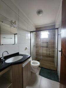 a bathroom with a toilet and a sink and a shower at DOURADOS GUEST FLAT PEDRA BONITA in Dourados