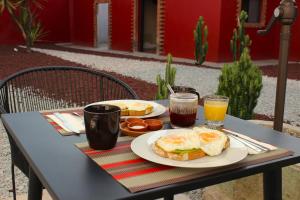 a table with two plates of breakfast food and drinks at Posada Independencia in Oaxaca City