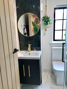 a bathroom with a sink and a mirror at THE MORNINGSIDE APARTMENT Charming stylish apartment in the centre of Innerleithen in Innerleithen