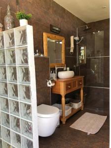 a bathroom with a sink and a toilet and a mirror at villa Oulad Hassoune in Mellah Bakka