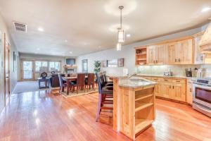 an open kitchen with wooden cabinets and a dining room at #301 Grand Lodge South Master Suite in Government Camp