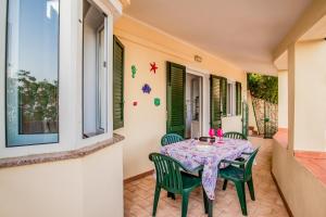 a table and chairs on the porch of a house at Casa Stecchi in Capoliveri +21 photos