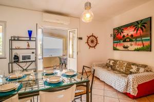 a living room with a table and a couch at Casa Stecchi in Capoliveri