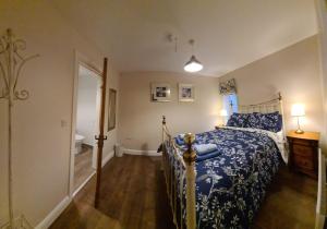 a bedroom with a bed and a bathroom with a tub at The Manor Guest Accommodation in Dungiven
