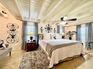 a bedroom with a bed and a ceiling fan at A Tranquil Retreat Loaded With Ambiance! Sleeps 10 in Platt
