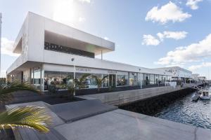a large building with a marina in front of it at Ohana in Arrecife