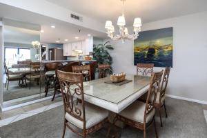 a dining room and kitchen with a dining table and chairs at Surf Dweller 207 in Fort Walton Beach