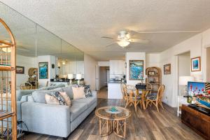 a living room with a couch and a table at Island Sands Resort 302 in Wailuku