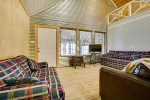 a living room with two couches and a flat screen tv at Golden Meadow Getaway Waterfront Retreat with Deck in Golden Meadow