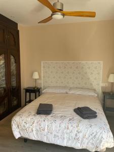a bedroom with a bed with two towels on it at VISTAS A SANTO DOMINGO in León