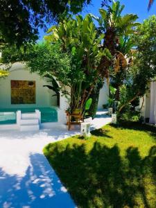 a backyard with a pool and trees and grass at Dar chelbia in Hammamet