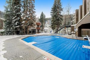 a large blue swimming pool in the middle of a building at Iron Horse Resort D3084 in Winter Park