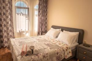 a bedroom with a bed with towels on it at Melia lux apartment in Ravda