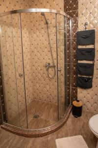a shower with a glass door in a bathroom at Melia lux apartment in Ravda