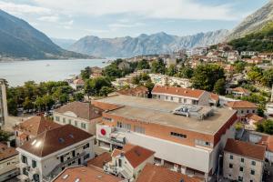 an aerial view of a town with a river and mountains at Kotor Central Point in Kotor