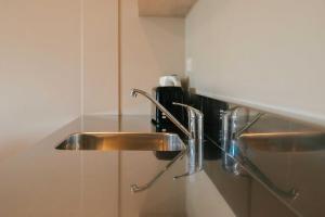 a stainless steel sink in a bathroom at South Street West Motel in Feilding