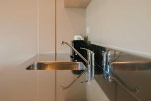 a stainless steel sink in a bathroom at South Street West Motel in Feilding +45 photos